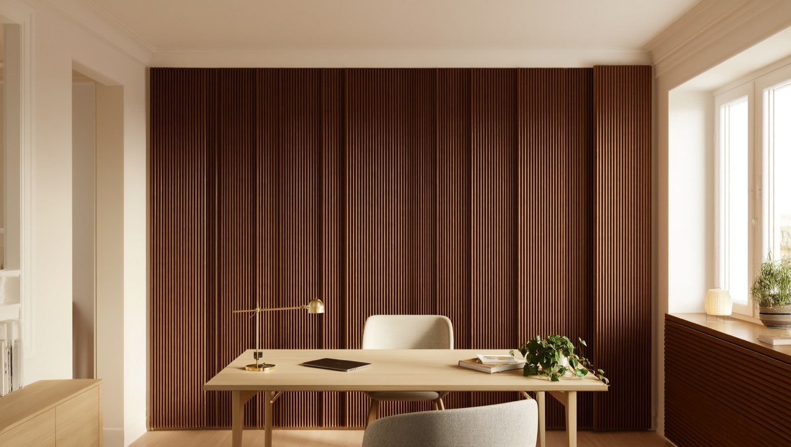 Home office accent wall clad in deep Ebony 3D fluted acoustic wood slat panels behind a light-oak desk in bright daylight